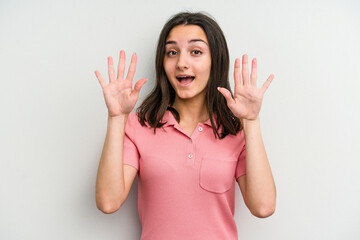 Young caucasian woman isolated on white background receiving a pleasant surprise, excited and raising hands.