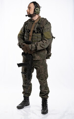 soldier in the studio on a white background. a man in military uniform with a rifle or machine gun. military or airball player