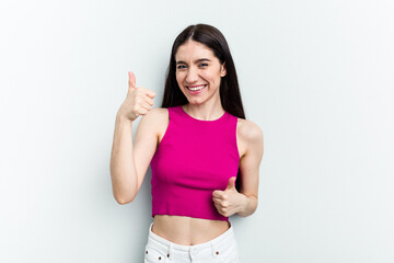 Young caucasian woman isolated on white background raising both thumbs up, smiling and confident.