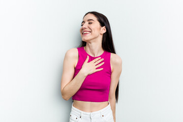 Fototapeta na wymiar Young caucasian woman isolated on white background laughs out loudly keeping hand on chest.