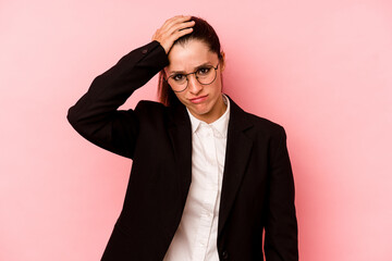 Young business caucasian woman isolated on pink background being shocked, she has remembered...