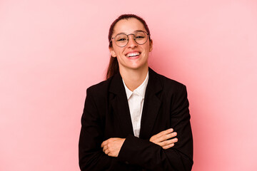 Young business caucasian woman isolated on pink background laughing and having fun.