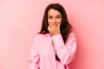 Young caucasian woman isolated on pink background doubting between two options.