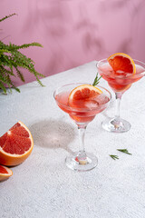 Summer refreshing sparcling cocktails with grapefruit. Lemonade garnished with fresh rosemary. Summer beverage with sparkling water and grapefruit slices.