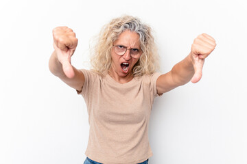 Middle age caucasian woman isolated on white background showing thumb down and expressing dislike.