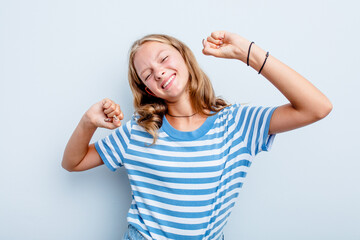 Fototapeta premium Caucasian teen girl isolated on blue background celebrating a special day, jumps and raise arms with energy.
