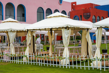 White table and chair arrangement and chandelier for outdoor tent party
