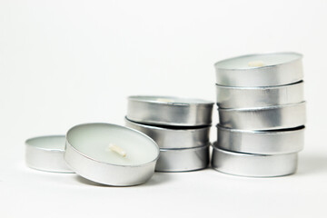Tea candles on a white background. Set of tea lights.