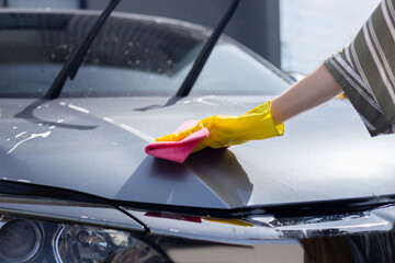 young female daugther wash and car detailing after automative car wash with family at home vehicle garage in sunny holiday