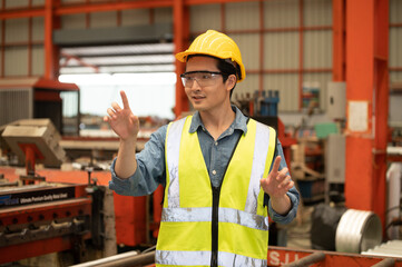 Asian man engineer  working hard in factory , worker employee  hard hat safety control machine...