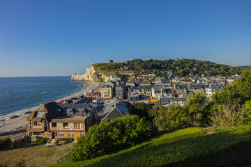 Obraz premium Aerial view of Etretat at sunset. Etretat is commune in Seine-Maritime department in Haute-Normandie region in northwestern France. Etretat - famous French seaside resort, known for its chalk cliffs.