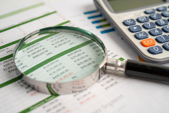 Magnifying glass on spreadsheet and calculator. Financial development, Banking Account, Statistics, Investment Analytic research data economy, Stock exchange trading, Business office concept.