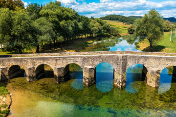 Fototapeta na wymiar Aerial view of the old stone bridge on the Dobra River, Croatia
