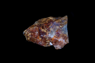 Rough specimen, Oregon common opal; brown, red, white and translucent. Conchoidal fractures. Weight 36.8 grams. Black background.
