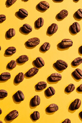 Roasted coffee beans on yellow background
