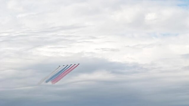 Saint-Petersburg, Russia. Flying display and aerobatic show of the Russian Military Air Force. Jet planes flying in the sky witn smoke trails in colors of Russian flag. 