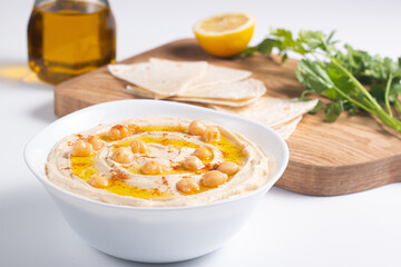Delicious hummus with chickpeas, olive oil, lemon and pita bread. Vegetarian food concept. 