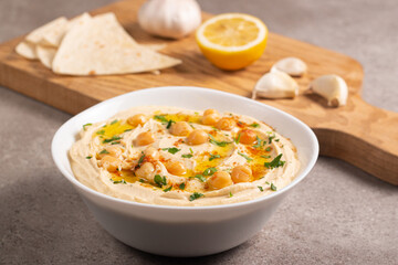 Delicious hummus with chickpeas, olive oil, lemon and pita bread. Vegetarian food concept. 
