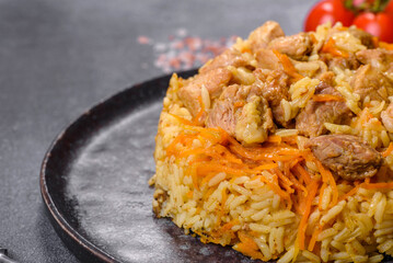 Pilaf or pilau with chicken, traditional uzbek hot dish of boiled rice and chicken meat