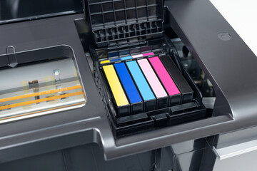 Close up of a multicolor ink cartridges of a inkjet printer. Cartridges change concept