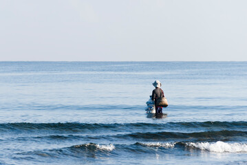 Fisherman carryong fishing net in the sea