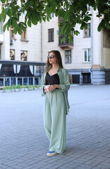 beautiful girl walks around the city with coffee. High quality photo