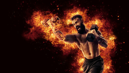 Handsome bearded shirtless tattooed bodybuilder workout wih dumbbell like boxer. Fire art concept