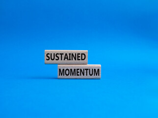 Sustained momentum symbol. Wooden blocks with words Sustained momentum. Beautiful blue background. Business and Sustained momentum concept. Copy space.