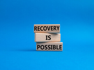 Recovery is possible symbol. Concept words Recovery is possible on wooden blocks. Beautiful blue background. Business and Recovery is possible concept. Copy space.
