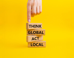 Think global act local symbol. Wooden blocks with words Think global act local. Beautiful yellow...