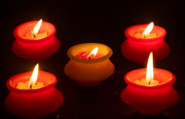 Obraz na płótnie Canvas Burning Candles Against Black Background during diwali festival