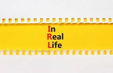 IRL in real life symbol. Concept words IRL in real life on yellow paper on a beautiful white background. Business and IRL in real life concept. Copy space.