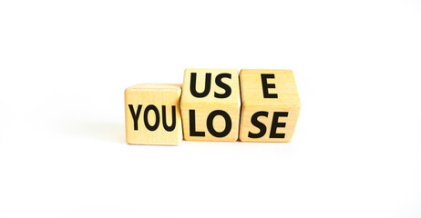 You use or lose it symbol. Concept words You use and You lose on wooden cubes. Beautiful white table white background. Business and you use or lose it concept. Copy space.