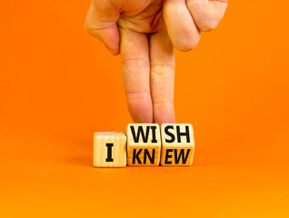 I knew or wish symbol. Concept words I knew and I wish on wooden cubes. Businessman hand. Beautiful orange table orange background. Business and I knew or wish concept. Copy space.