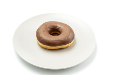 Tasty Donut dessert with chocolate glossy glaze in a plate, isolated on white background. One round chocolate doughnut cake for your design and print