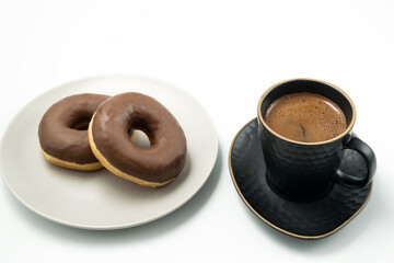 Coffee and Donut with chocolate glossy glaze in a plate, isolated on white background.