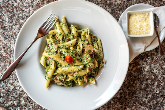 Prosciutto Penne With Spinach - colorful pasta plate served with Parmigiano Reggiano