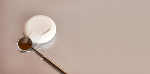 Dental mirror and dental floss on a gray background. Dental care.