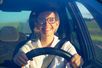 Young woman driving car on a sunny summer day