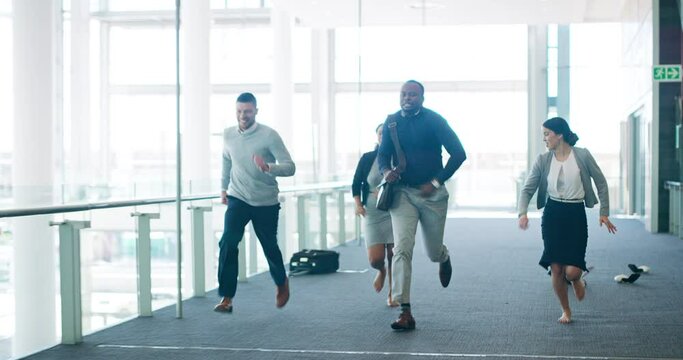 Fun, Excited And Happy Business Group Running Through Their Office Building. Young Entrepreneurs Kicking Off Their Shoes And Throwing Down Bags While Dashing. Workers Racing Each Other In The Office.