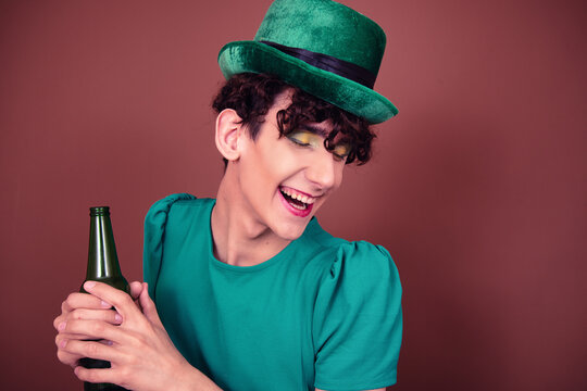 A Guy Dressed As A Drag Queen Drinks Beer. St.Patrick 's Day.