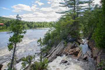 Fototapeta na wymiar Waterfalls on a beautiful wild river in Quebec in Canada