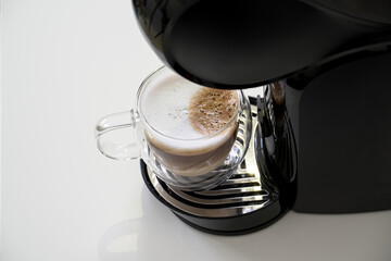 Coffee capsule machine Making cappuccino in glass cup
