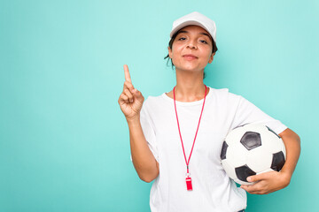 Young hispanic soccer referee woman isolated on blue background showing number one with finger.