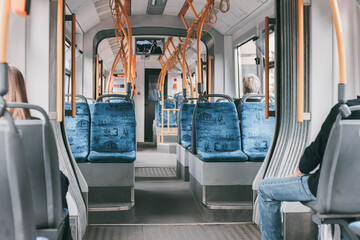 Tram interior with empty seats in old fashion public city transport - obrazy, fototapety, plakaty