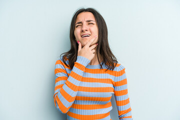 Young caucasian woman isolated on blue background having a strong teeth pain, molar ache.