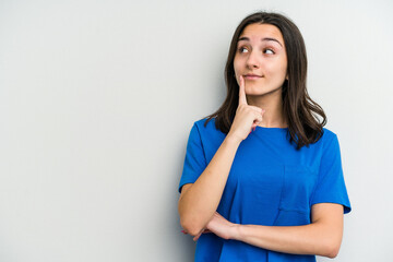Young caucasian woman isolated on white background looking sideways with doubtful and skeptical expression.