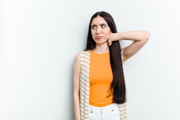 Young caucasian woman isolated on white background touching back of head, thinking and making a choice.