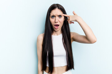 Fototapeta premium Young caucasian woman isolated on blue background showing a disappointment gesture with forefinger.