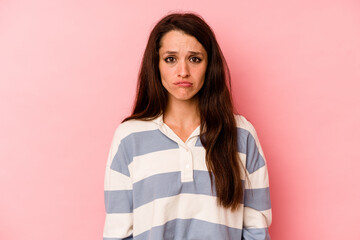 Fototapeta premium Young caucasian woman isolated on pink background sad, serious face, feeling miserable and displeased.